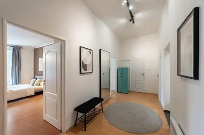 a room with a bed and a chair and a mirror at Klidný byt v centru se saunou in Prague
