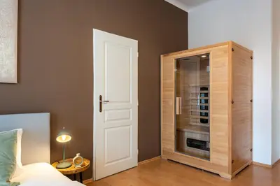 a bedroom with a closet with a glass door at Klidný byt v centru se saunou in Prague