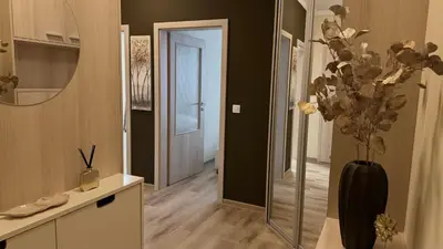 a hallway with a vase with flowers in it at Brownie Prague Design Apartment, free garage parking in Prague