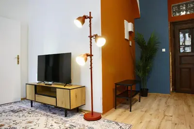 a living room with a television and a floor lamp at Prague Properties Rental in Prague
