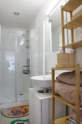 a bathroom with a white sink and a shower at Prague Properties Rental in Prague