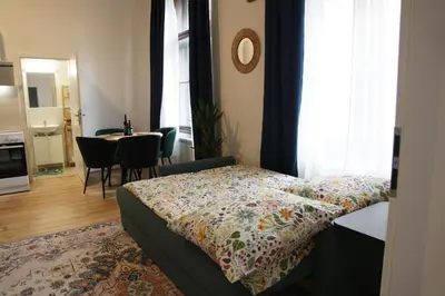 a bedroom with a bed and a kitchen and a table at Prague Properties Rental in Prague