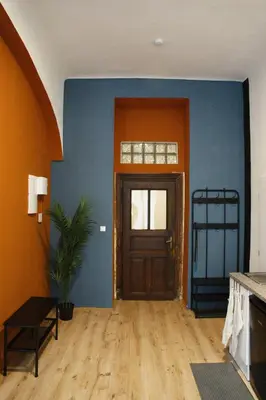 a hallway with a door in a room with blue walls at Prague Properties Rental in Prague