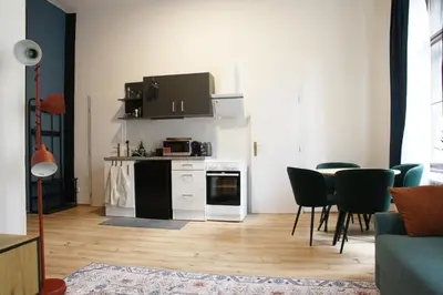 a living room with a kitchen with a table and chairs at Prague Properties Rental in Prague