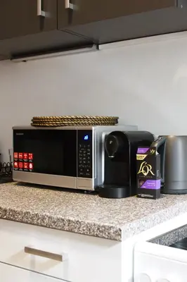 a microwave sitting on a counter in a kitchen at Prague Properties Rental in Prague