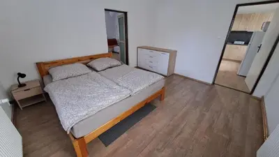 a bedroom with a bed with a blue comforter at Byt v okolí letiště a Prahy in Velké Číčovice