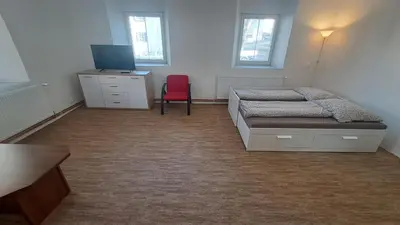 a bedroom with a bed and a large mirror at Byt v okolí letiště a Prahy in Velké Číčovice