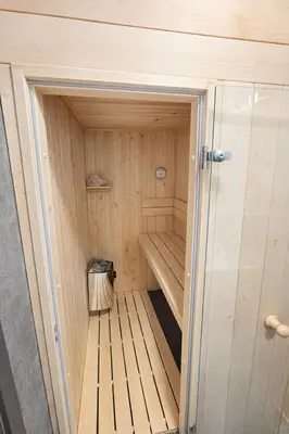 a small sauna with a trashcan in the middle at Ubytování Městská hora Beroun - Sauna in Beroun