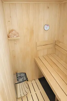 a small sauna with a clock on the wall at Ubytování Městská hora Beroun - Sauna in Beroun