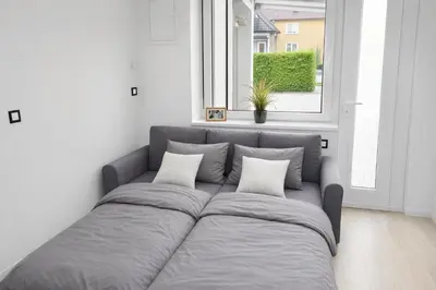 a bed in a white room with a window at Ubytování Městská hora Beroun - Sauna in Beroun