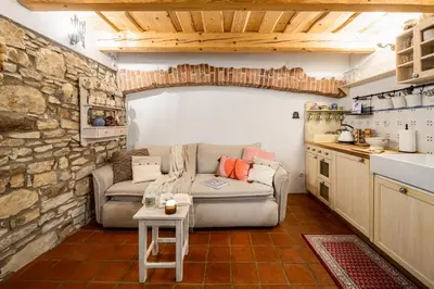 a living room with a couch and a kitchen at Prague Days - Cozy House near Prague Castle with Desk and Balcony in Prague