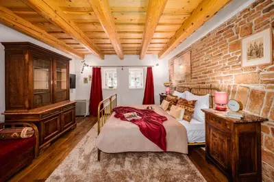 a bedroom with a bed and a brick wall at Prague Days - Cozy House near Prague Castle with Desk and Balcony in Prague