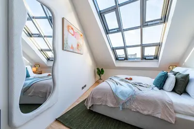 a bedroom with two beds and a mirror at Prague Days - Three Bedroom Apartment with Terrace and AC in Prague