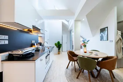 a kitchen and dining room with a table and chairs at Prague Days - Three Bedroom Apartment with Terrace and AC in Prague
