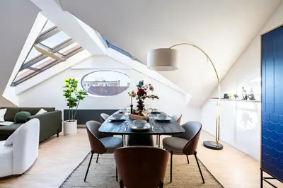 a dining room with a table and chairs at Prague Days - Three Bedroom Apartment with Terrace and AC in Prague