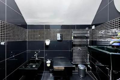 a black bathroom with a sink and a sink at Prague Days - Three Bedroom Apartment with Terrace and AC in Prague