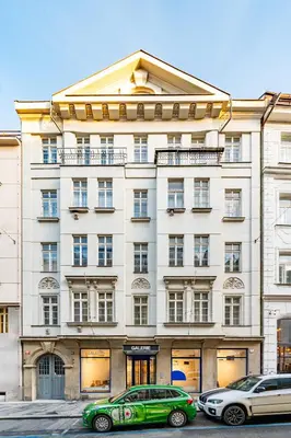 two cars parked in front of a building at Prague Days - Three Bedroom Apartment with Terrace and AC in Prague