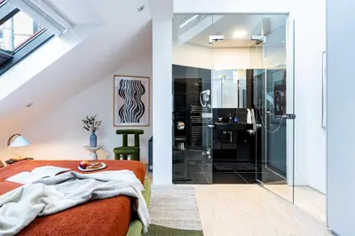 a bathroom with a shower and a bed in a room at Prague Days - Three Bedroom Apartment with Terrace and AC in Prague