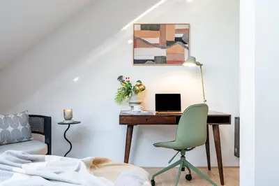 a bedroom with a desk with a laptop and a chair at Prague Days - Three Bedroom Apartment with Terrace and AC in Prague