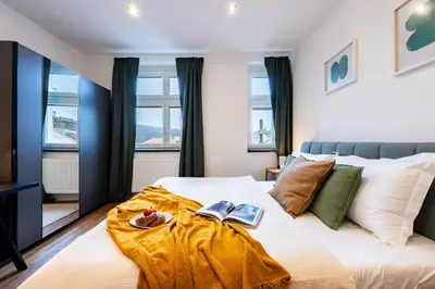 a table with four bottles of wine on it at Prague Days - Two Bedroom Riverside Apartment with Gramophone in Prague