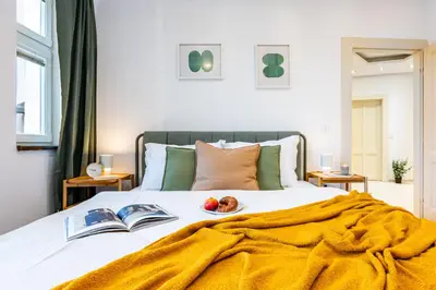 a bathroom with a white sink and a mirror at Prague Days - Two Bedroom Riverside Apartment with Gramophone in Prague