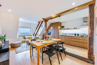 a kitchen with wooden cabinets and a sink at Prague Days - Two Bedroom Riverside Apartment with Gramophone in Prague