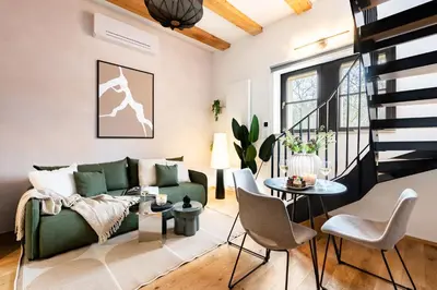 a living room with a green couch and a table at Prague Days - One Bedroom Apartment with Garage and Workspace in Prague
