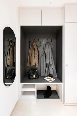 a walk in closet with white cabinets and a mirror at Prague Days - One Bedroom Apartment with Garage and Workspace in Prague