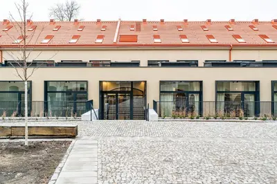 an office building with a red roof at Prague Days - One Bedroom Apartment with Garage and Workspace in Prague
