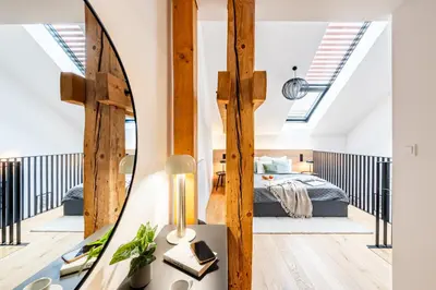 a bedroom with a bed and a mirror at Prague Days - One Bedroom Apartment with Garage and Workspace in Prague