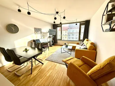 a living room with a couch and a table at River Diamond Central Residence in Prague