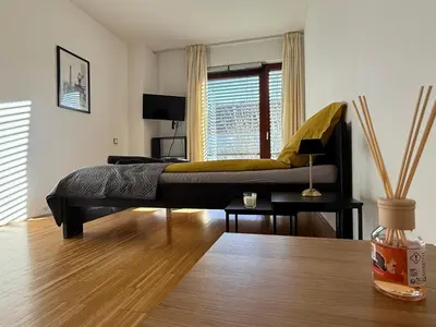 a bedroom with a bed with a yellow blanket on it at River Diamond Central Residence in Prague