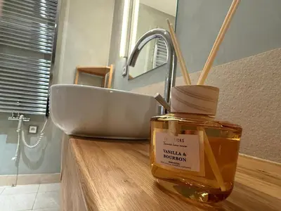 a jar of honey sitting on a counter next to a sink at River Diamond Central Residence in Prague