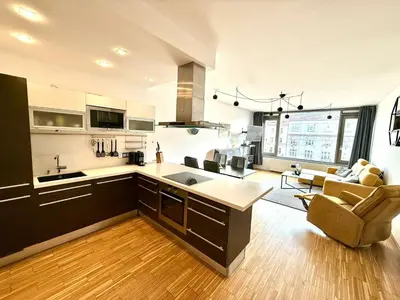 an open kitchen and living room with a couch at River Diamond Central Residence in Prague