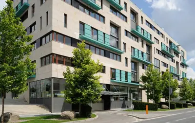 an apartment building on the corner of a street at River Diamond Central Residence in Prague
