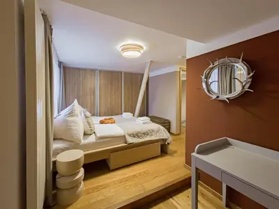 a bedroom with a bed with a mirror on the wall at Triplex Apartment with Private Terrace in Prague