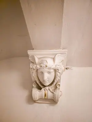 a statue of a head on a wall at Triplex Apartment with Private Terrace in Prague