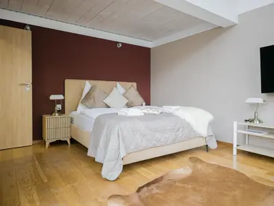 a bedroom with a large bed and a television at Triplex Apartment with Private Terrace in Prague