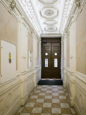 an empty hallway with a door and a tile floor at Triplex Apartment with Private Terrace in Prague