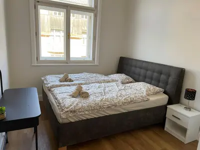 a bedroom with a bed with two teddy bears on it at Quiet Apartment Farmers' Saturday Market in Prague