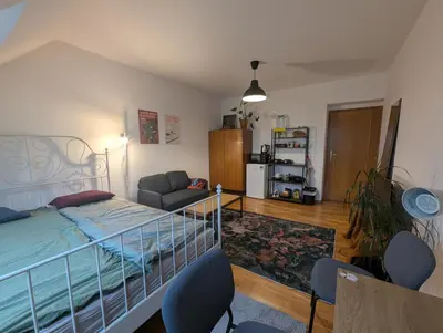 a bedroom with a bed and a living room at Cozy Studio-Room Near center with Private Bathroom in Prague
