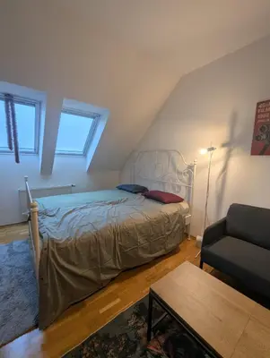 a bedroom with a bed and a couch at Cozy Studio-Room Near center with Private Bathroom in Prague