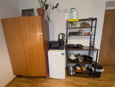 a kitchen with a small refrigerator and a shelf at Cozy Studio-Room Near center with Private Bathroom in Prague