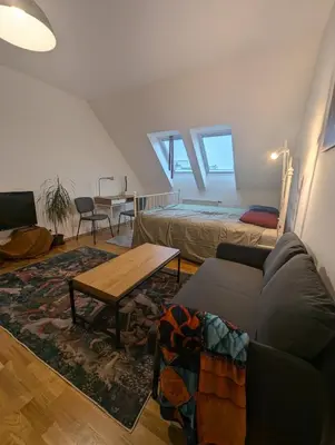 a living room with a couch and a table at Cozy Studio-Room Near center with Private Bathroom in Prague
