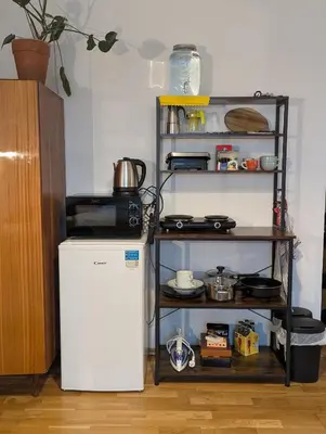 a kitchen with a white refrigerator and a shelf at Cozy Studio-Room Near center with Private Bathroom in Prague