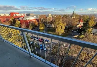 a view of a parking lot from a balcony at Panoramic top floor flat across the metro in Prague