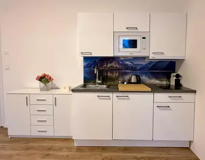 a white desk with a vase of flowers on it at Prague 1 - Central Cozy Apartment in Prague