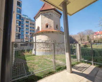 a tower behind a fence next to a building at Kajetanka Residence - with free weekend parking in Prague