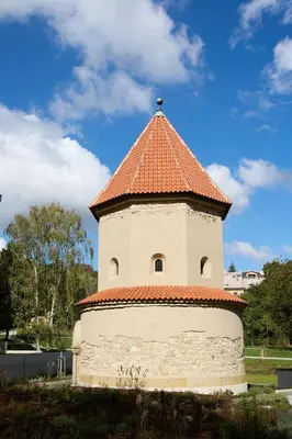 a tower with an orange roof on a field at Kajetanka Residence - with free weekend parking in Prague