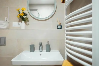 a bathroom with a sink and a mirror at Kajetanka Residence - with free weekend parking in Prague